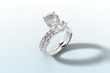 Load image into Gallery viewer, Oval lab diamond engagement ring with hidden halo and double-row french pave shank in 14k white gold, three-quarter view
