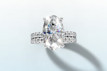 Load image into Gallery viewer, Top view of oval lab diamond ring showing four-prong setting and pave band in 14k white gold
