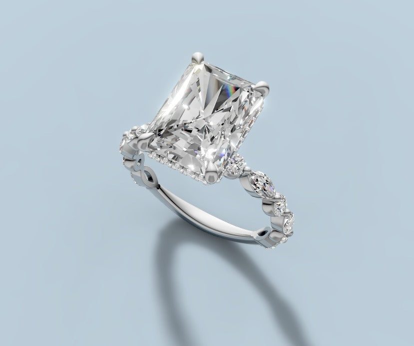Radiant lab diamond engagement ring with hidden halo and alternating marquise and round bezel band in 14k white gold, three-quarter view