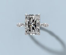 Load image into Gallery viewer, Top view of radiant lab diamond ring with claw prongs and alternating marquise and round diamonds along the band
